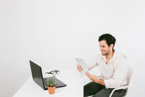 Smiley young man with tablet work
