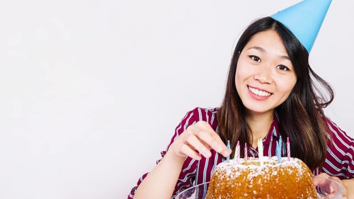 Smiling birthday girl with tasty cake