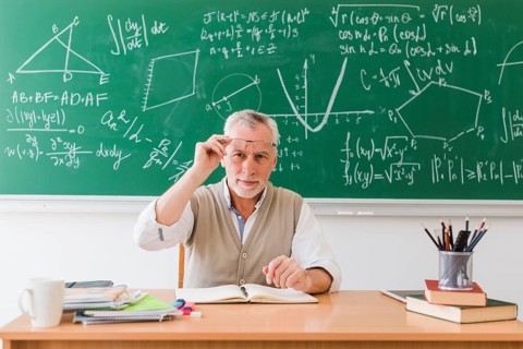 Smiling old professor maths classroom