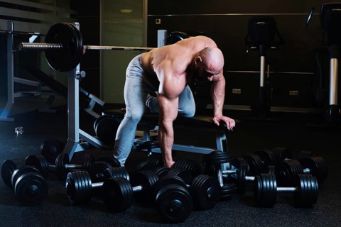 Sportsman preparing lift dumbbell
