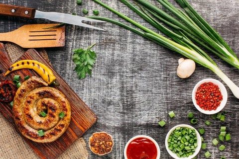 Tasty grilled sausages fresh vegetable old backdrop