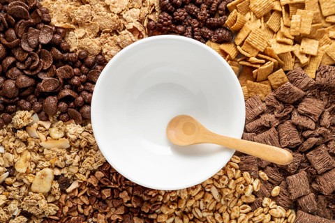 Top view assortment breakfast cereals with empty bowl