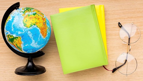 Top view back school supplies with glasses globe