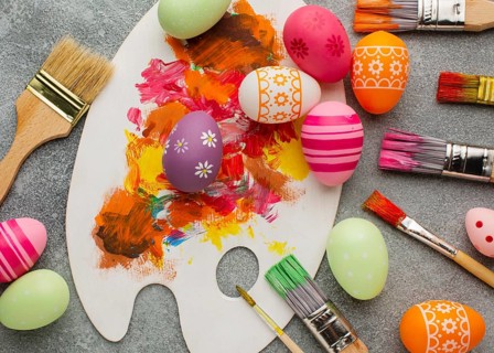 Top view colorful easter eggs with paint brushes palette