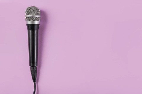 Top view microphone pink background