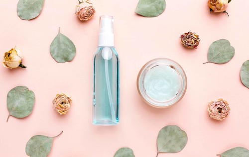 Top view organic cosmetic products with leaves