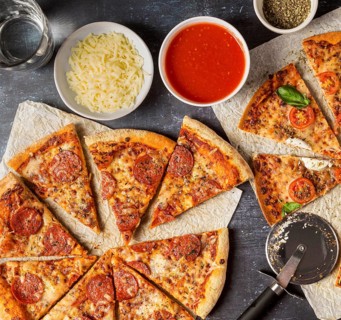 Top view sliced pizza with tomato sauce mozzarella
