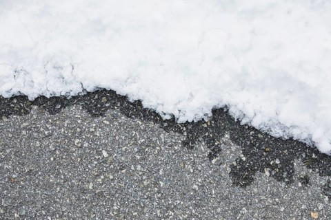 Wet asphalt near snow