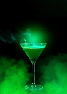 Wineglass with liquor green smoke