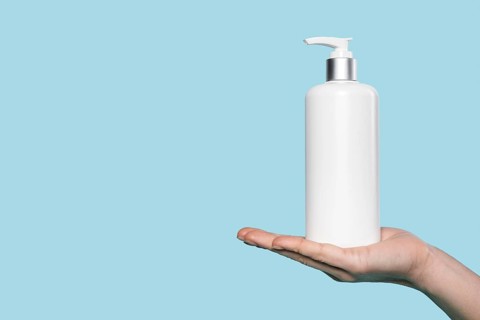 Woman holding liquid soap bottle