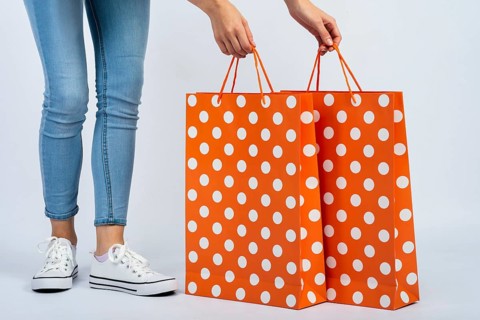 Woman holding shopping bags mock up near legs