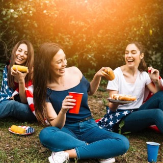Women sharing hot dogs