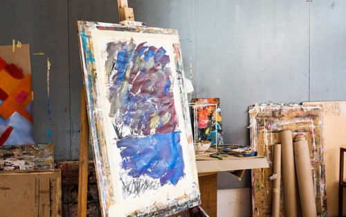 Wooden easel with messy painting artist s workshop