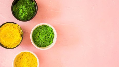 Yellow green holi color powder pink background
