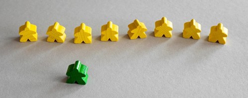 Yellow green meeple board game pieces