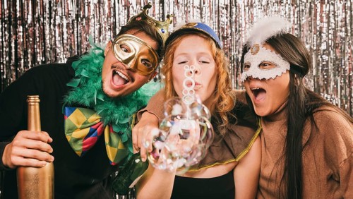 Young friends having fun carnival party
