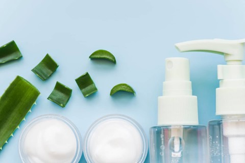 Aloe vera natural spray bottle cream beauty blue background