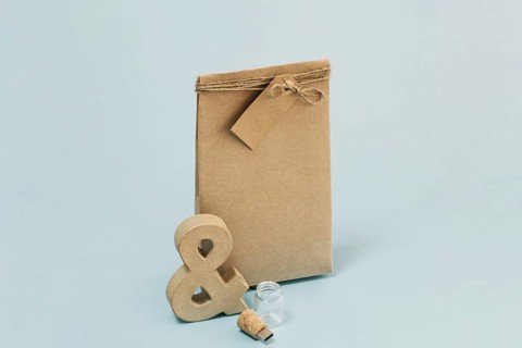 Ampersand flash drive near paper bag