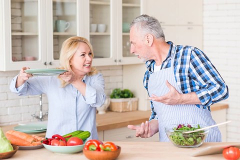 Angry senior couple fighting with each other kitchen