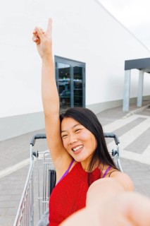 Asian woman posing taking selfie shopping trolley