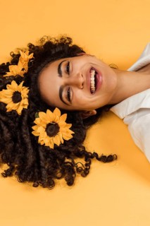 Attractive cheerful woman with flowers hair