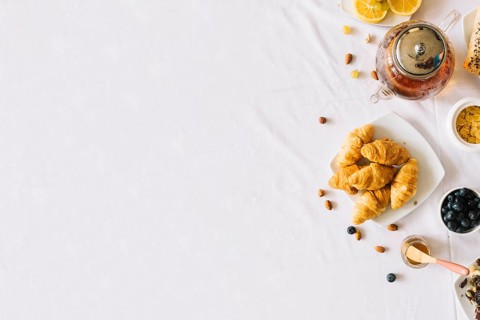 Baked croissant fruits tea dryfruits white background