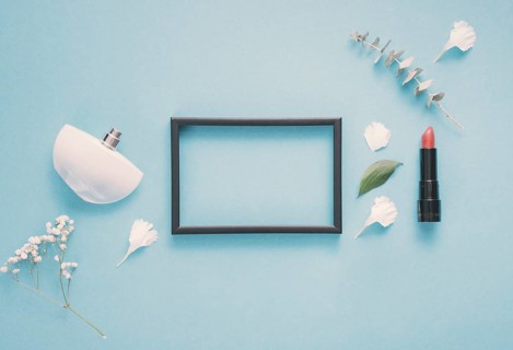 Blank frame with lipstick plants table