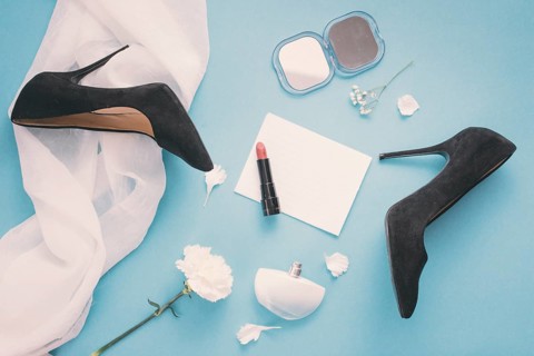 Blank paper with woman shoes lipstick table