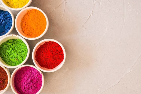 Bowls holi color powder concrete background
