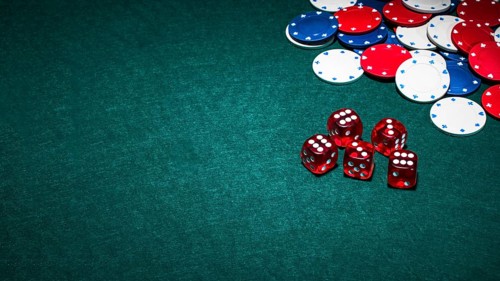 Bright red dices casino chips green poker background