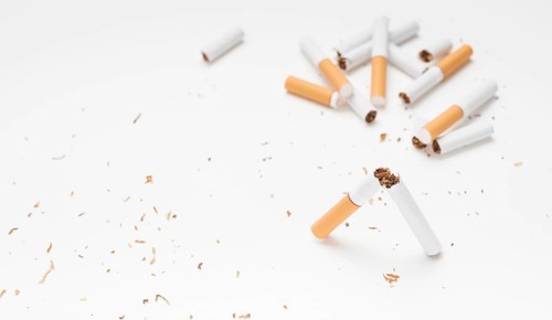Broken cigarette tobacco white surface