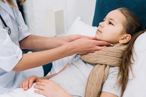 Close up female s doctor hand checking girl patient s throat neck