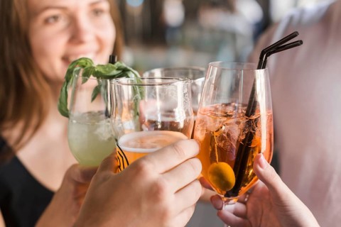 Close up friends toasting glasses cocktail