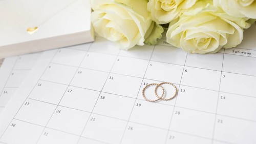 Close up gift box roses wedding rings calendar