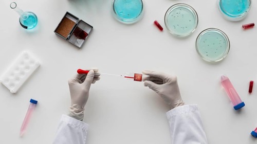 Close up hands holding pipette