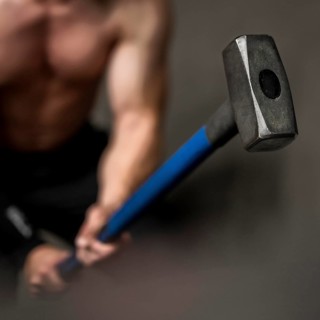 Close up man training with hammer
