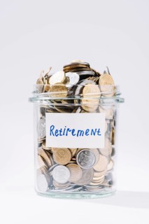 Close up retirement glass container full coins white background