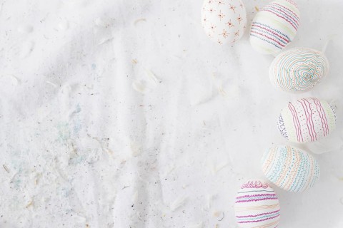 Collection easter eggs with patterns near quills textile