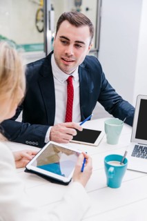 Content man chatting with colleagues table