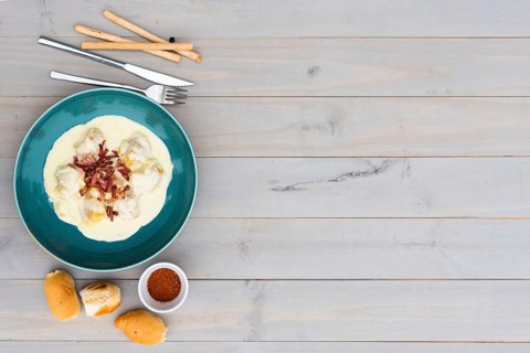 Creamy tasty italian pasta ceramic plate with bread meal wooden background