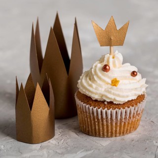 Delicious cupcake with crowns high view