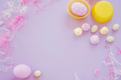 Easter eggs with small sweets purple table