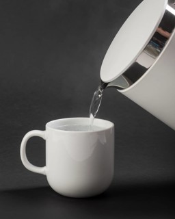 Electric kettle pouring water cup