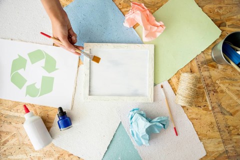 Elevated view woman s hand painting white paint mold