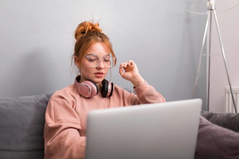 Female teacher using laptop from home hold online class