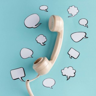Flat lay chat bubbles with telephone receiver