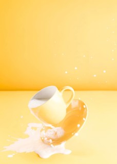 Floating yellow cup with spilling milk