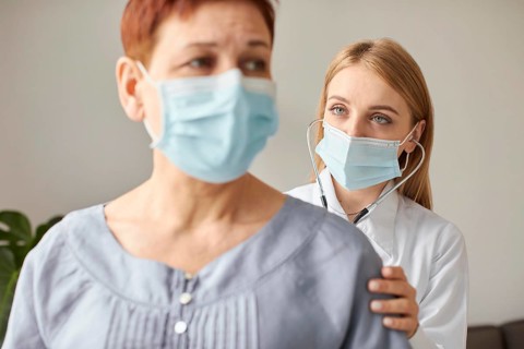 Front view elder patient with medical mask covid recovery center female doctor with stethoscope