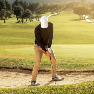 Front view man playing golf with club