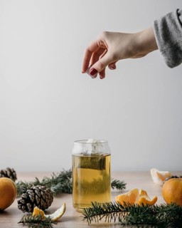 Front view person taking tea bag out jar